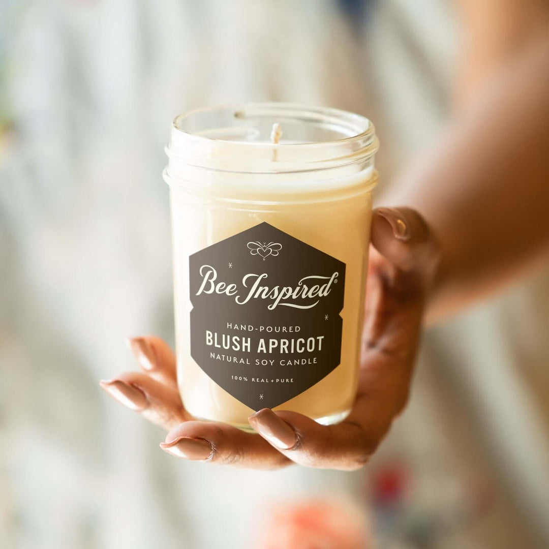 Blush Apricot jelly jar candle held in hand
