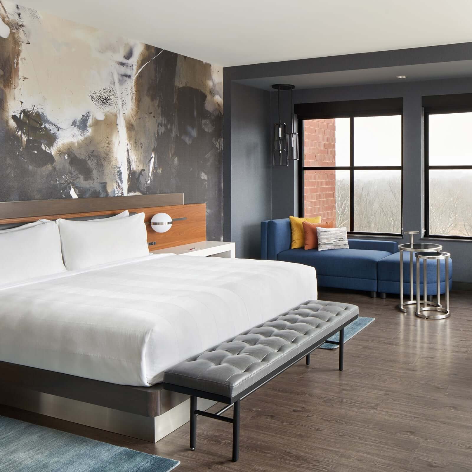 Bedroom with white, black, and gold painting on the wall