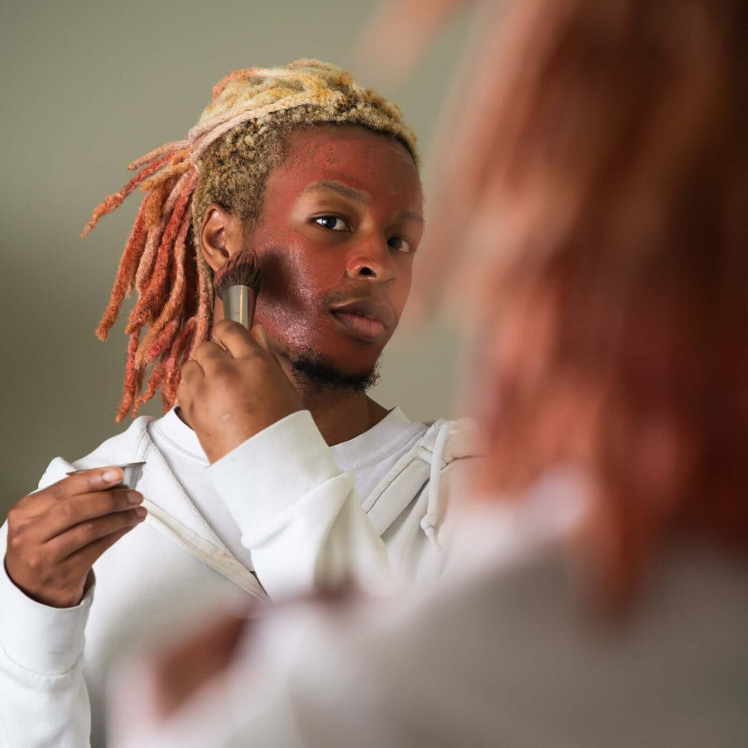 Man applies Clarity face mask in the mirror