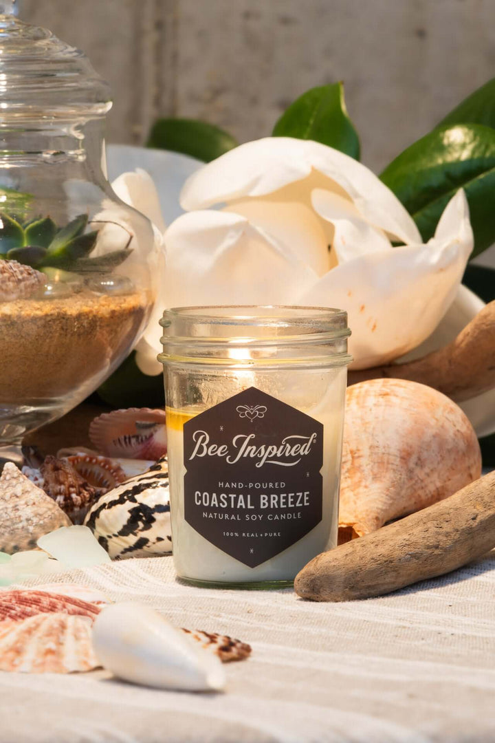 Coastal Breeze jelly jar candle burning next to nautical display
