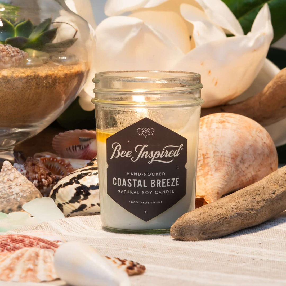 Coastal Breeze jelly jar candle burning next to nautical display