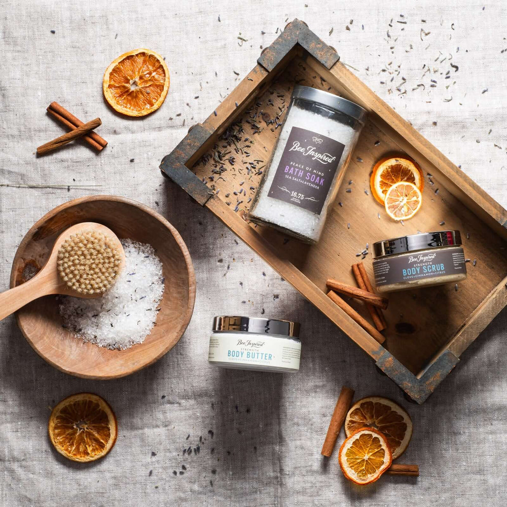 Foot Care Kit flat lay with cinnamon and dried orange slices on wooden trays