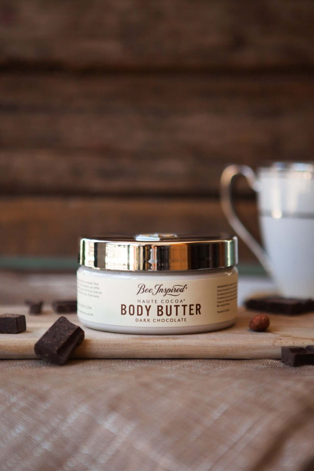 haute cocoa body butter from bee inspired honey retail store in owings mills on cutting board with pieces of dark chocolate