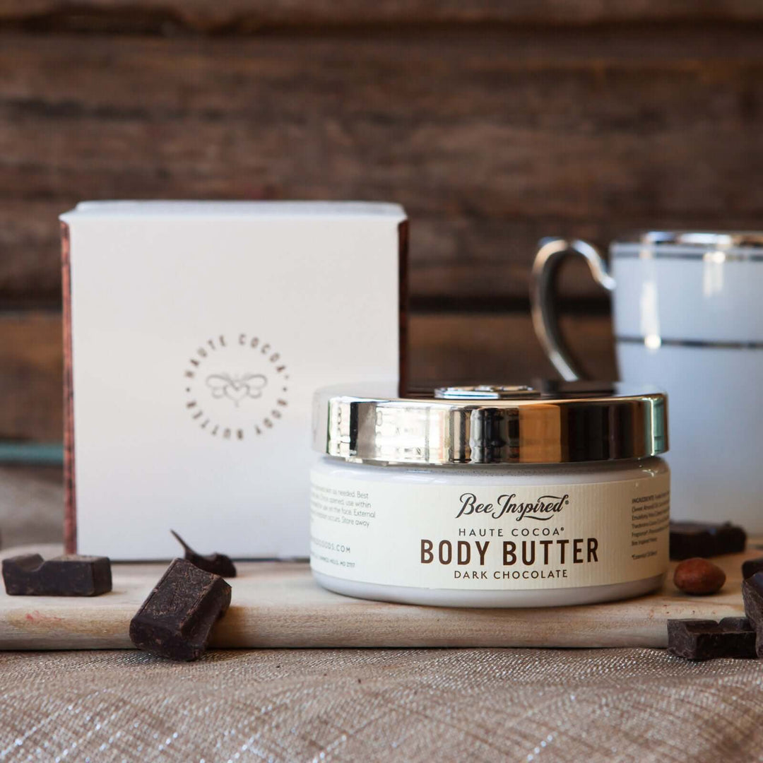 haute cocoa body butter from bee inspired honey retail store in owings mills with its box, a mug, and chocolate pieces