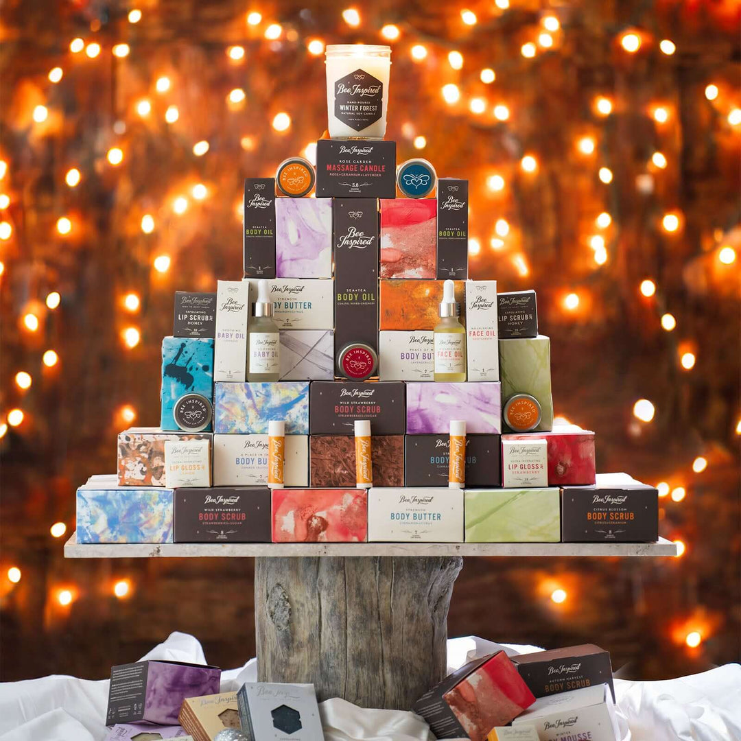 tree-shaped display of Bee Inspired products from bee inspired honey retail store in owings mills in front of holiday lights
