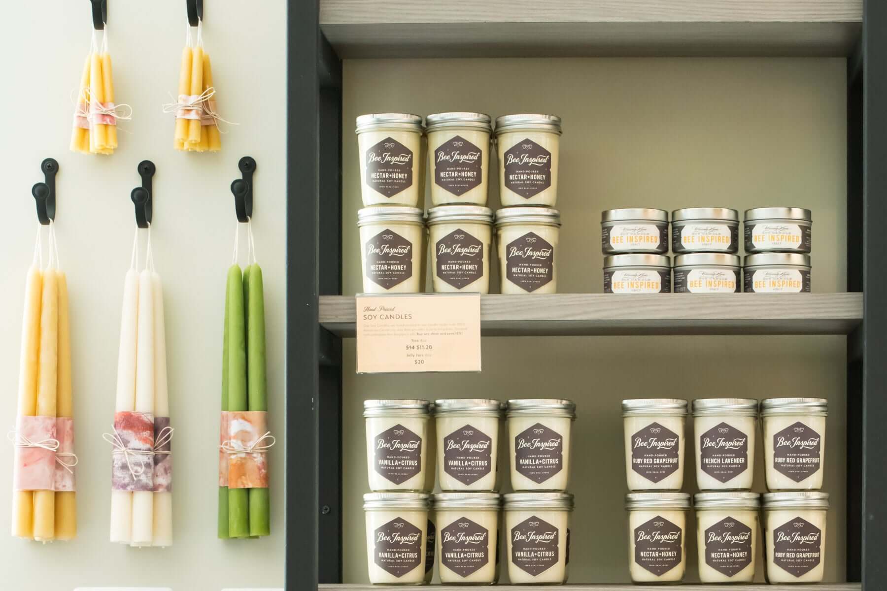 Honey house candle display with jelly jar, ceremony, and taper candles