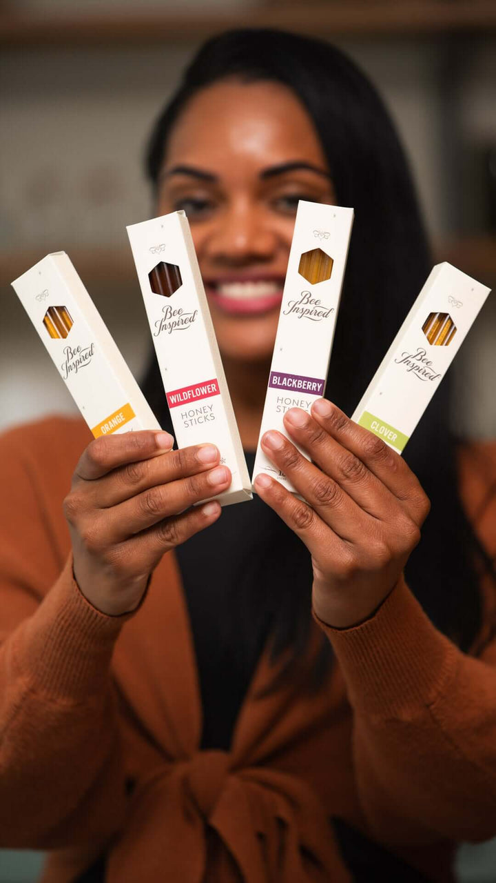 Woman holding boxes of varietal honey sticks