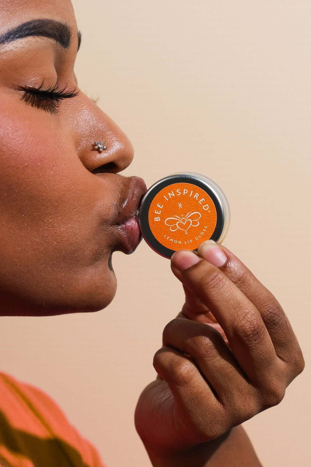 Kissing a tin of lemon lip gloss