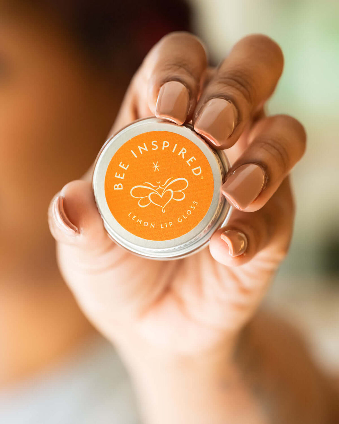 Person holding lemon lip gloss