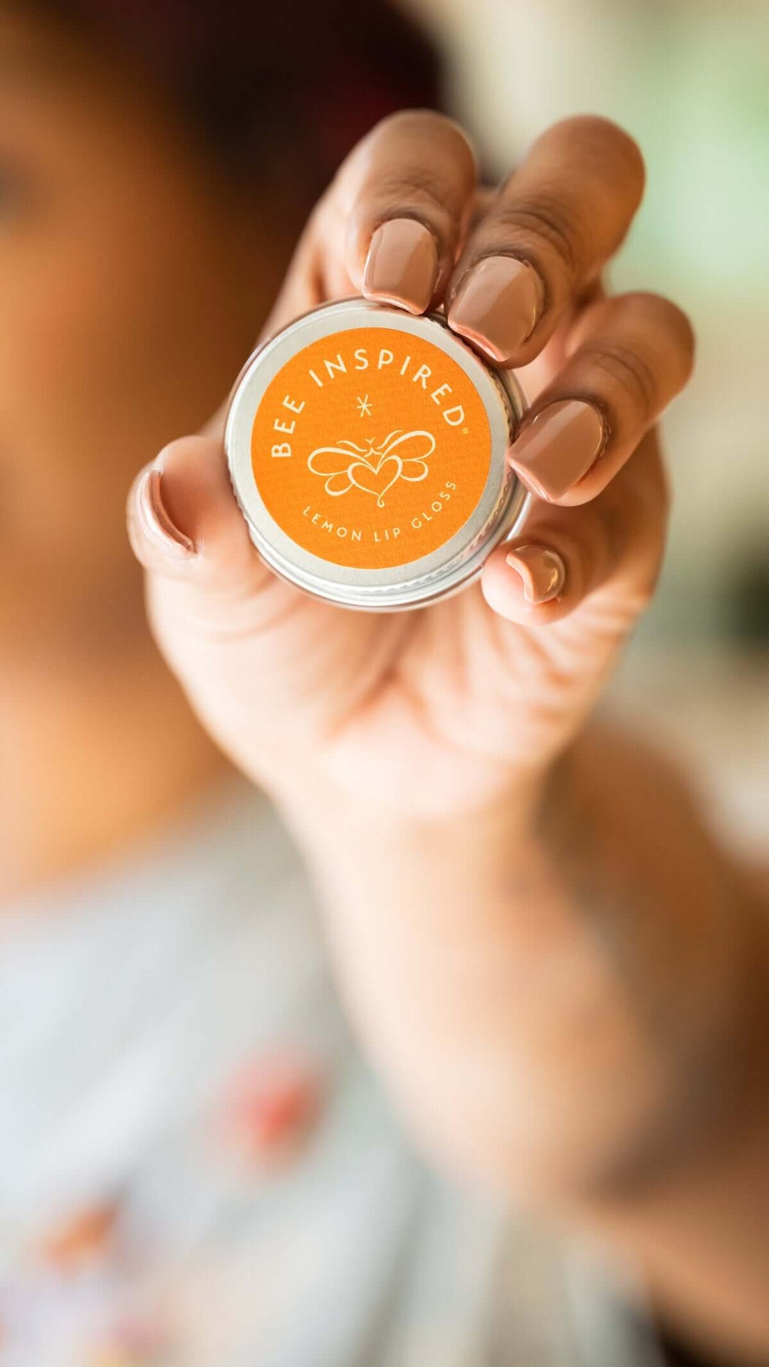 Person holding lemon lip gloss