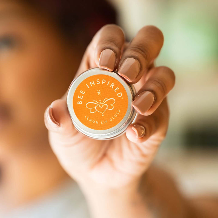 Person holding lemon lip gloss