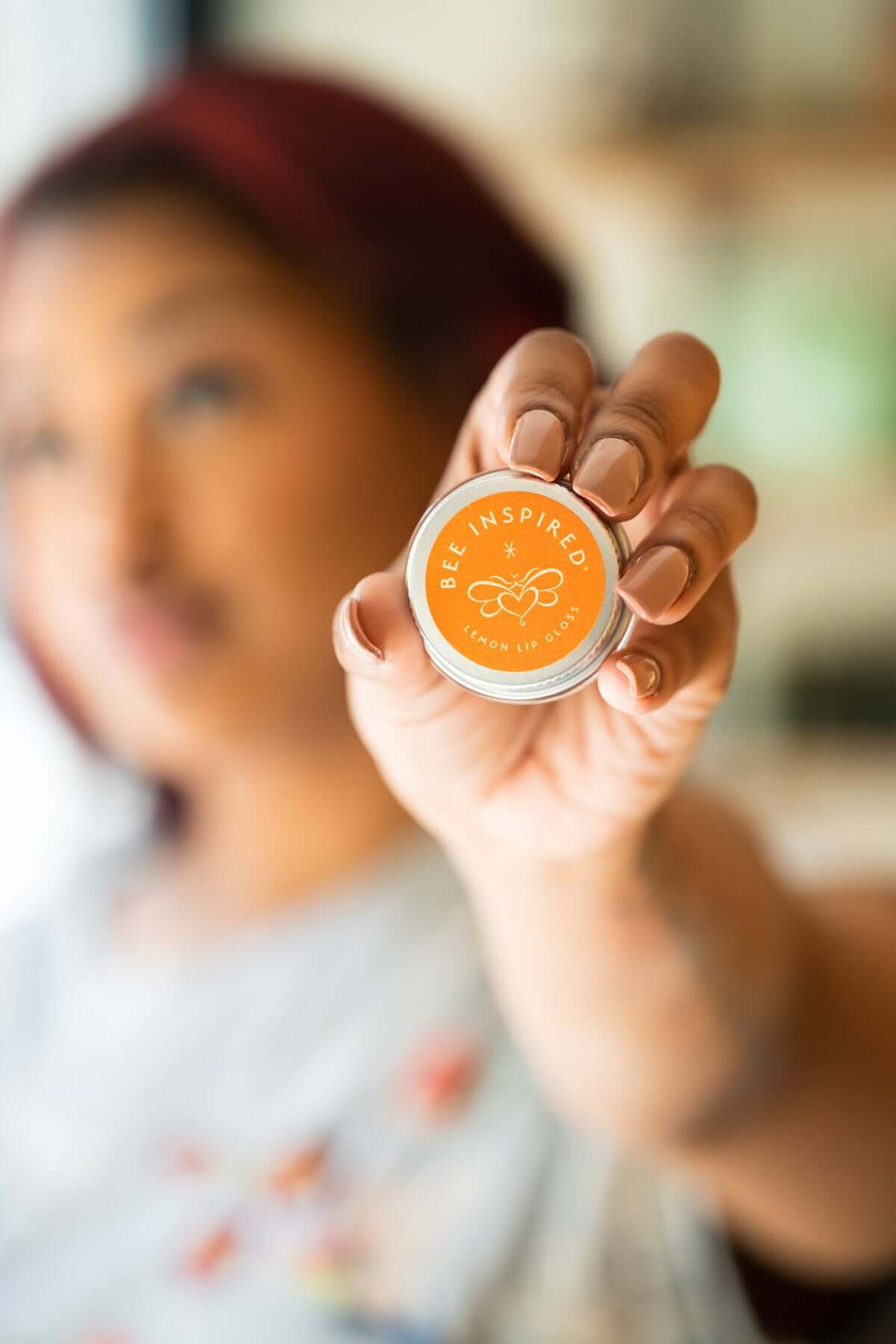 Person holding lemon lip gloss