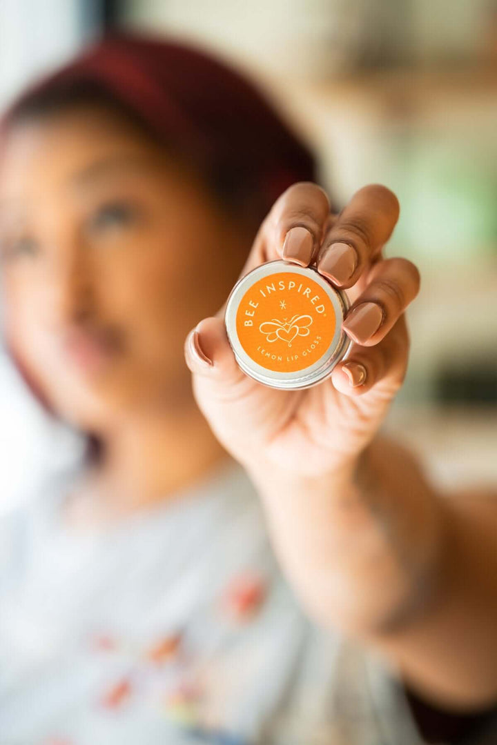 Person holding lemon lip gloss