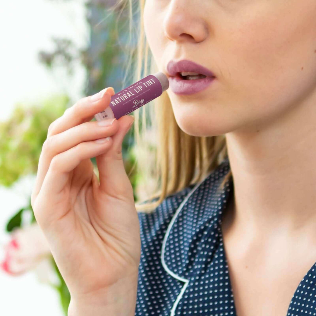 Woman applies Berry lip tint