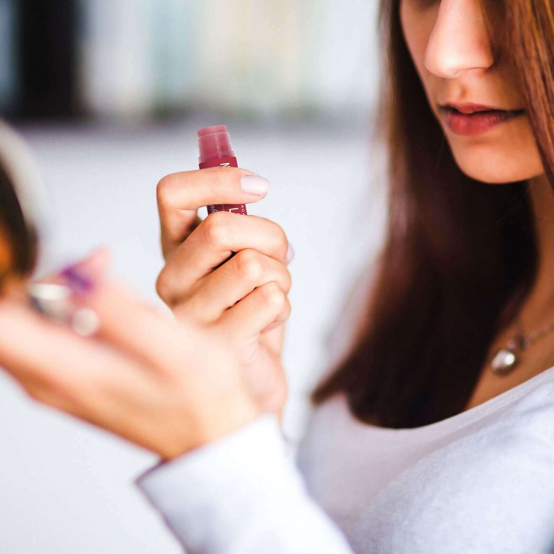 Woman holds Cranberry lip tint