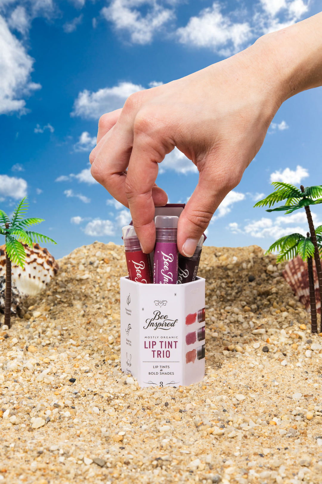 lip tint trio in bold shades on the beach