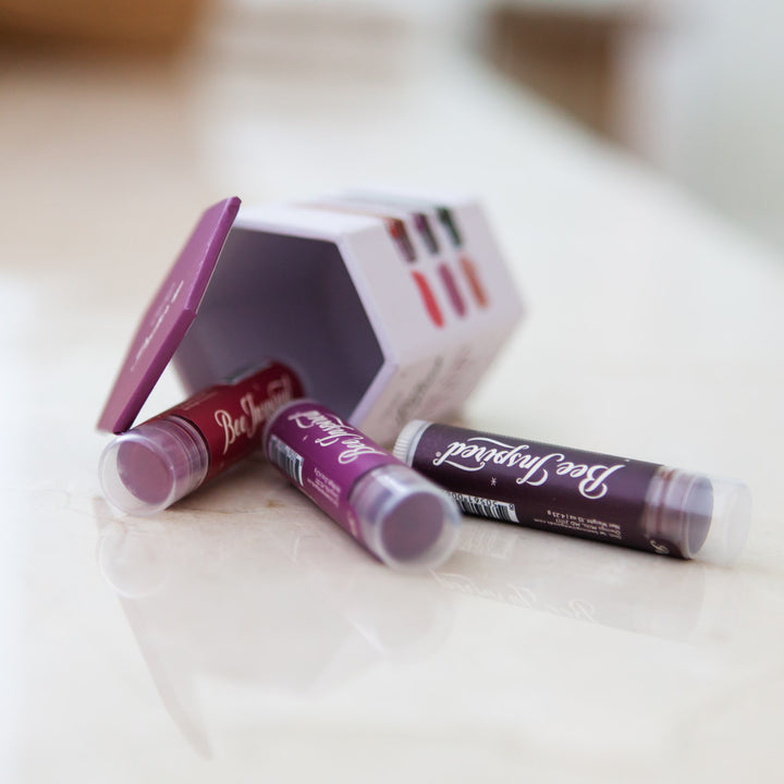 lip tint trio in bold shades spilling out on a counter