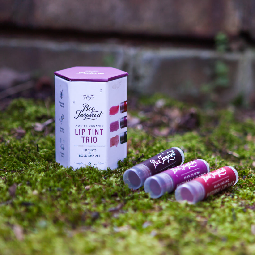 lip tint trio in bold shades outside in a bed of moss