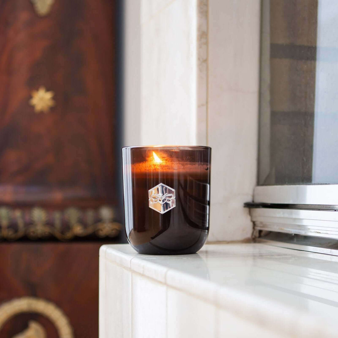 Luxe candle burning in windowsill
