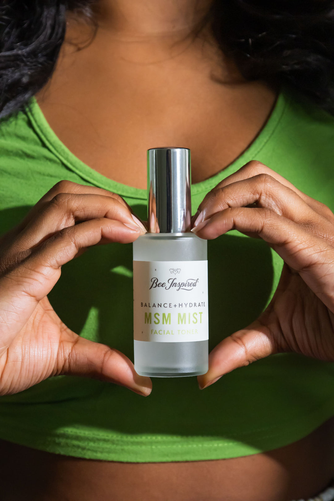 holding MSM Mist bottle between heart-hands