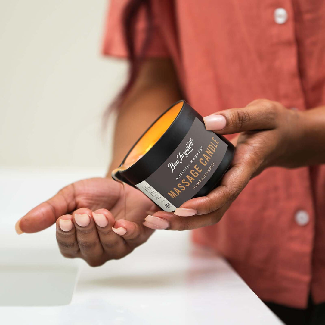 pouring oil of Autumn Harvest massage candle onto hand