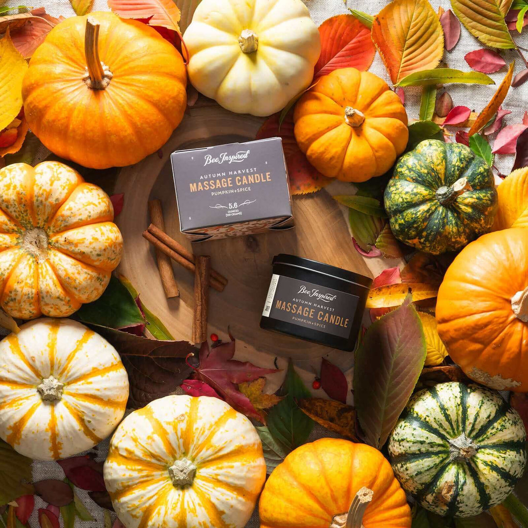 Autumn Harvest massage candle flat lay with cinnamon sticks and pumpkins