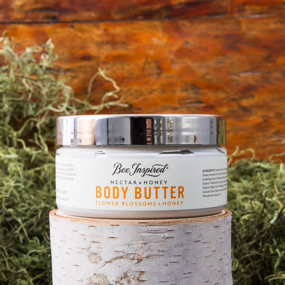 nectar and honey body butter in front of moss