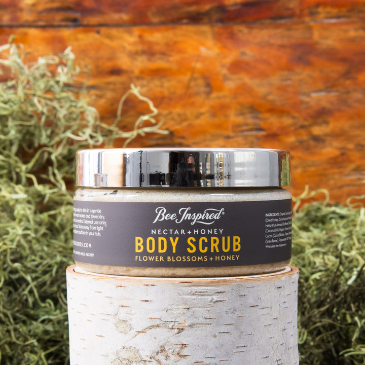 nectar and honey body scrub in front of moss