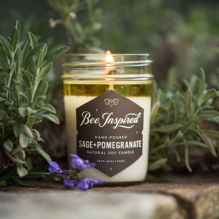 Sage+Pomegranate jelly jar candle burning in front of sage