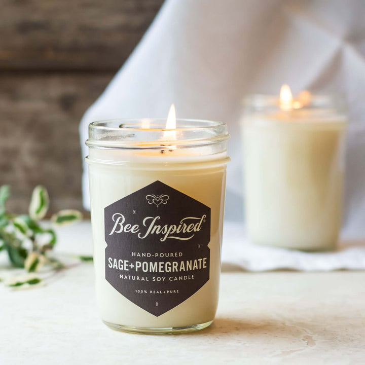 Sage+Pomegranate jelly jar candle burning on table