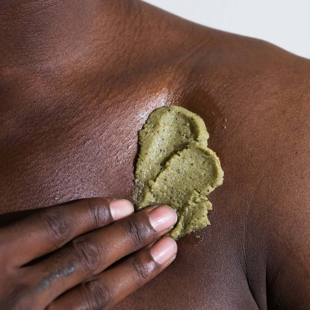 man applies Sea+Tea body scrub to his shoulder