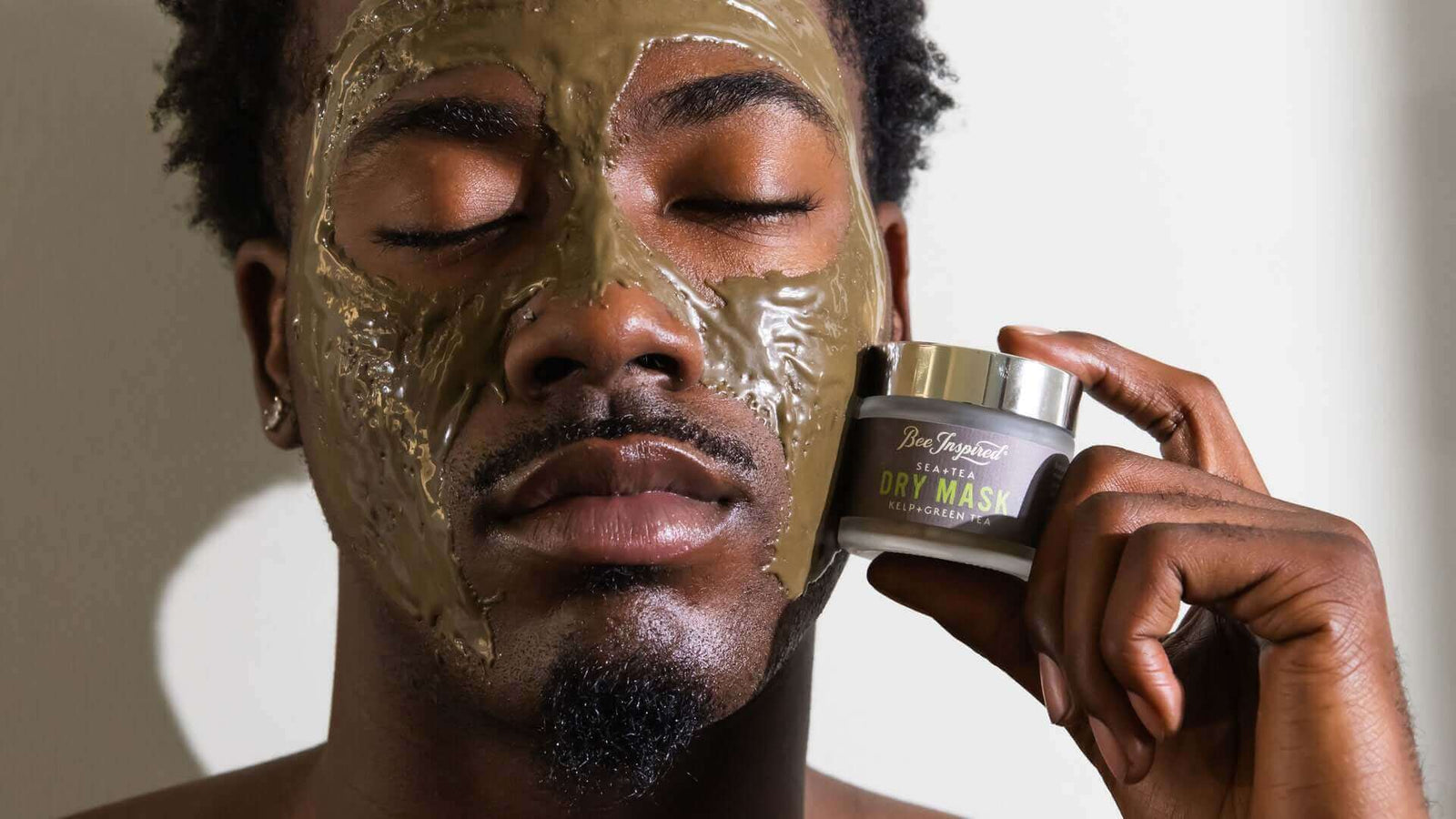 man with Sea+Tea mask applied on his face