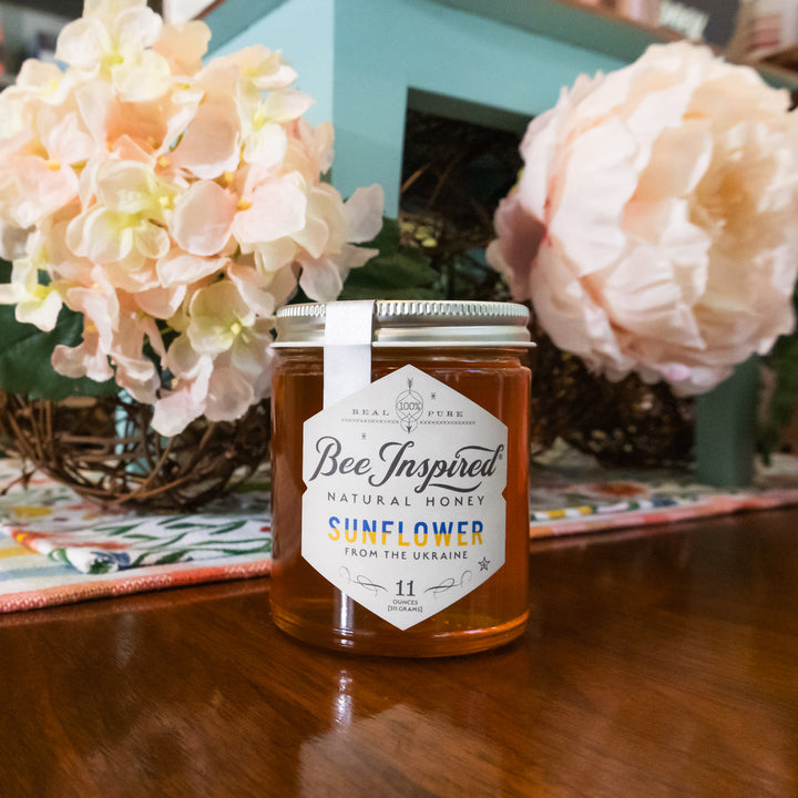 Ukrainian Sunflower honey in front of floral table centerpiece