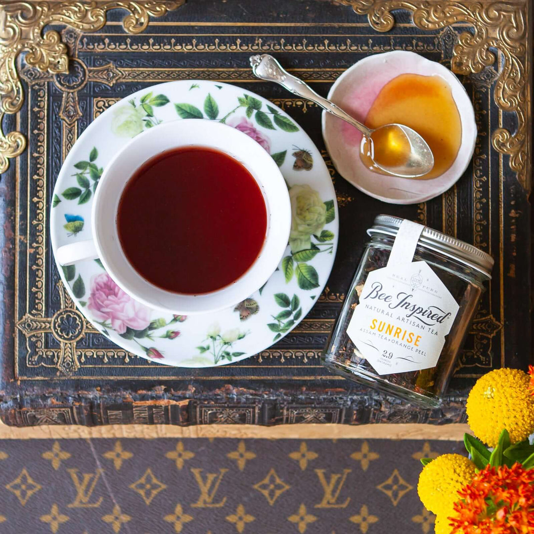 Sunrise Assam Tea on old book and Vuitton trunk