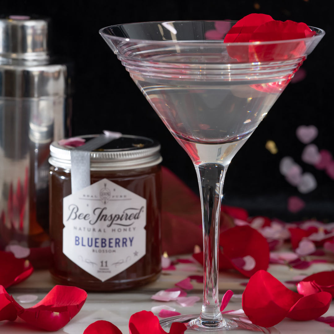 sweetheart martini made with Blueberry honey and garnished with rose petals