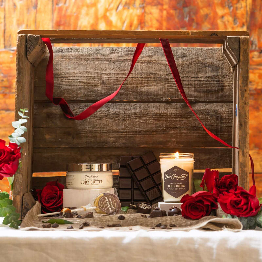 Haute Cocoa body butter and jelly jar candle next to a display with chocolates and roses