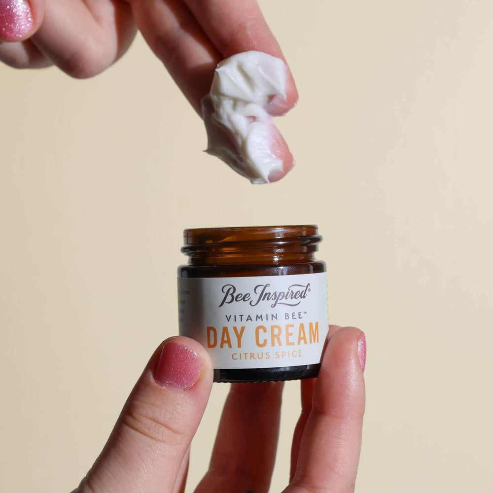Taking Vitamin Bee citrus spice day cream from the jar