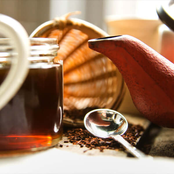 Jar of honey, tea kettle, and loose-leaf tea