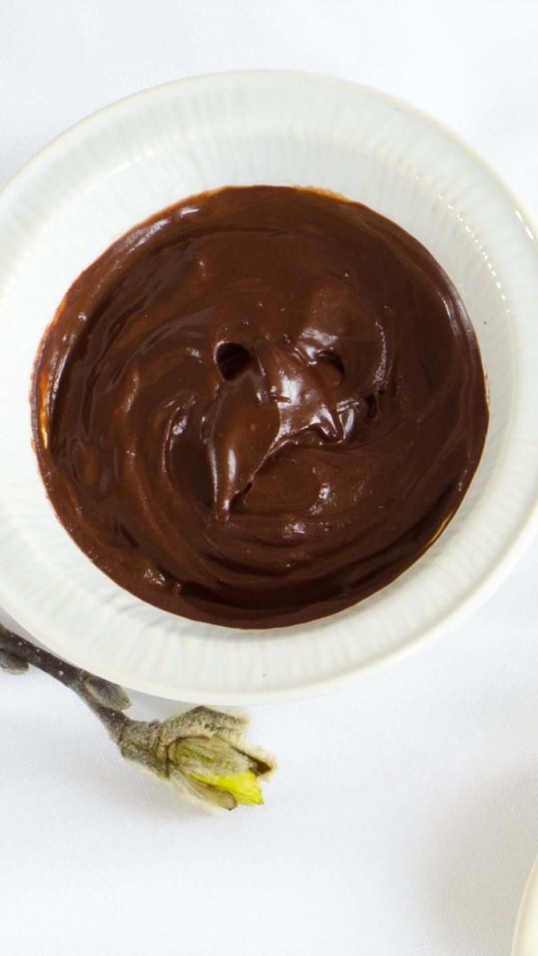 a cup filled with a brown colored cream