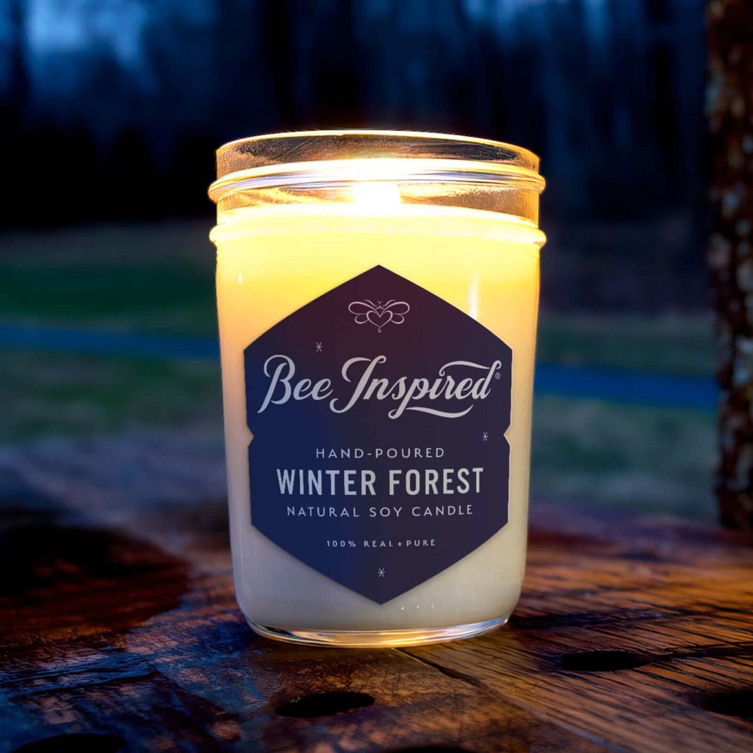 Winter Forest jelly jar candle burning on outdoor table