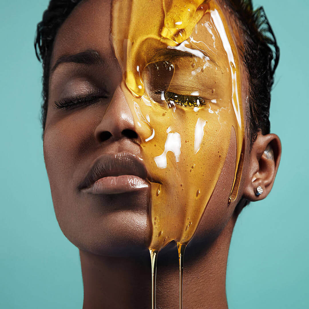 honey poured over half of a woman's face