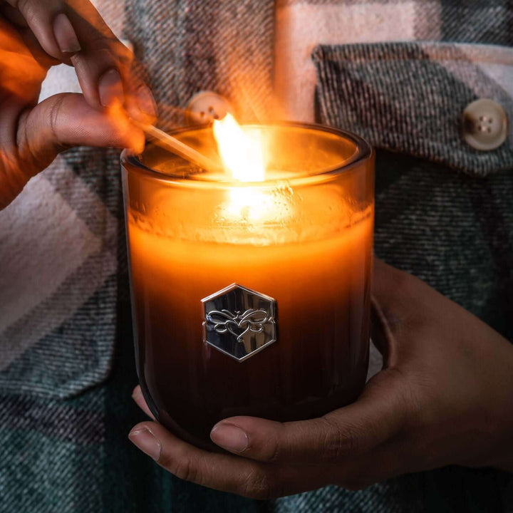 Lux candle lit with a match