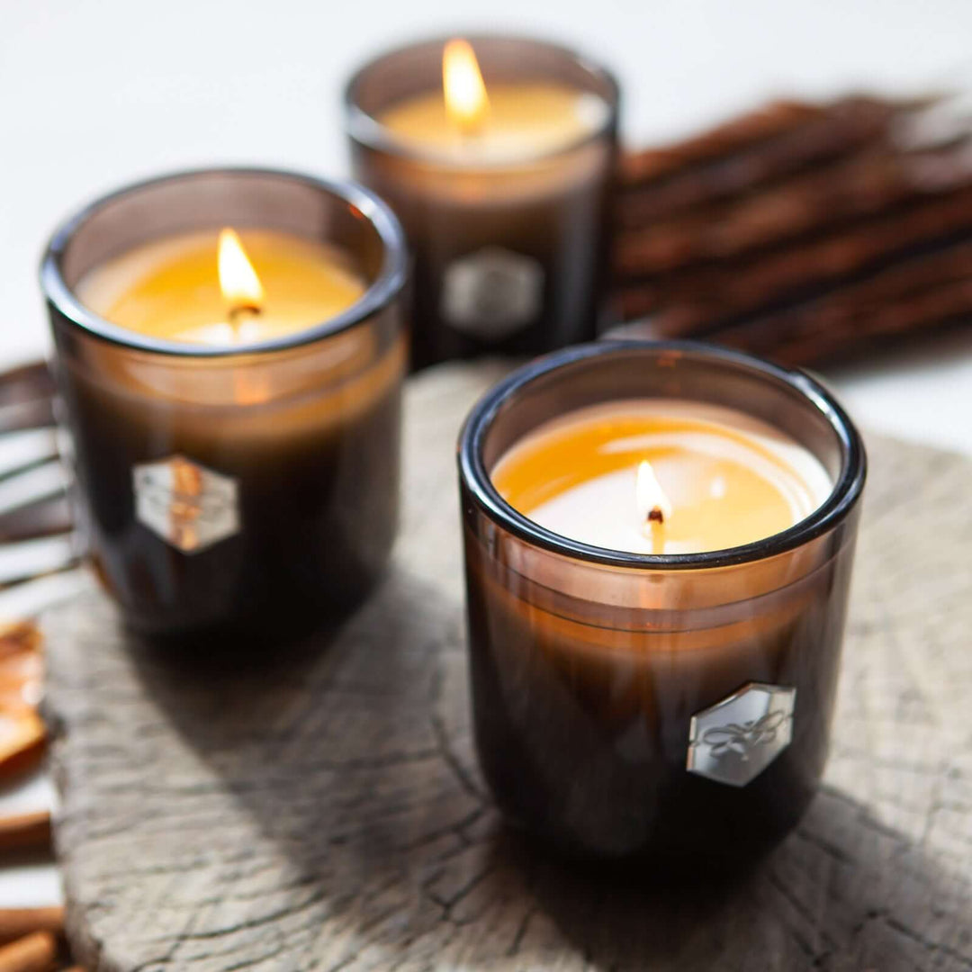 three luxe candles from bee inspired honey retail store in owings mills on wood