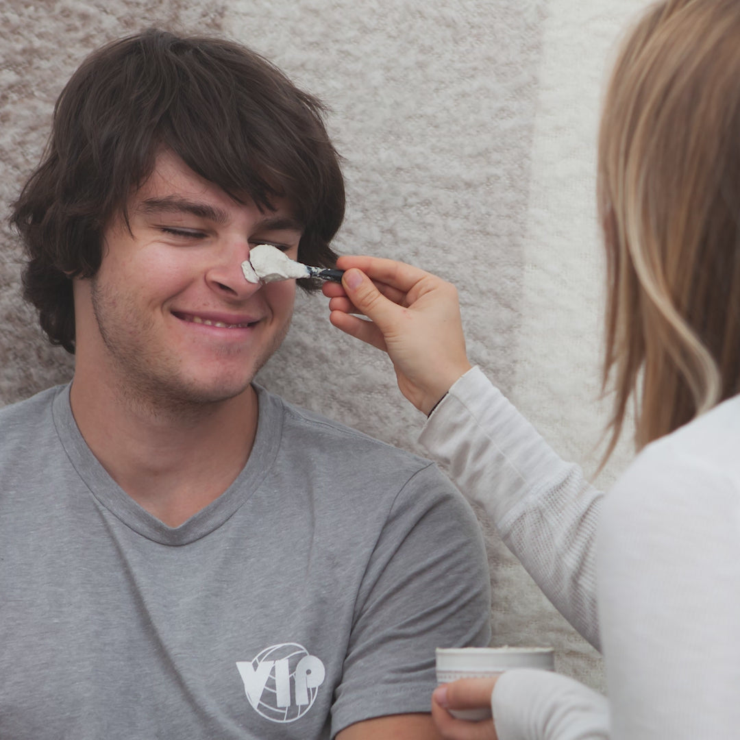 A short stop motion video of a girl applying a face mask to her boyfriend's face