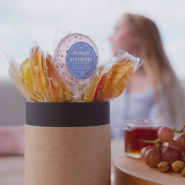 emily eating a honey lollipop from bee inspired honey retail store in owings mills on a yacht