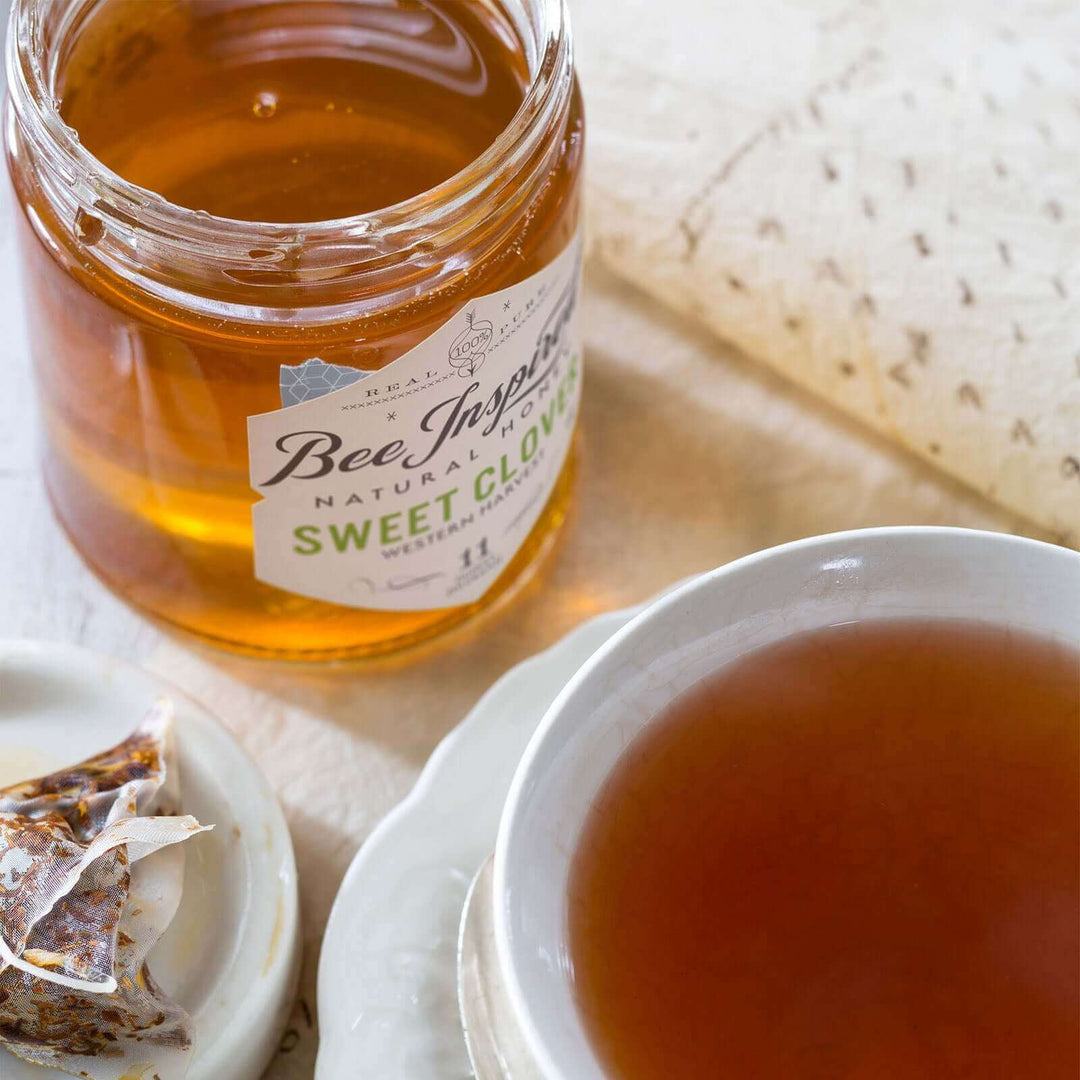 Sweet Clover honey next to mug of tea