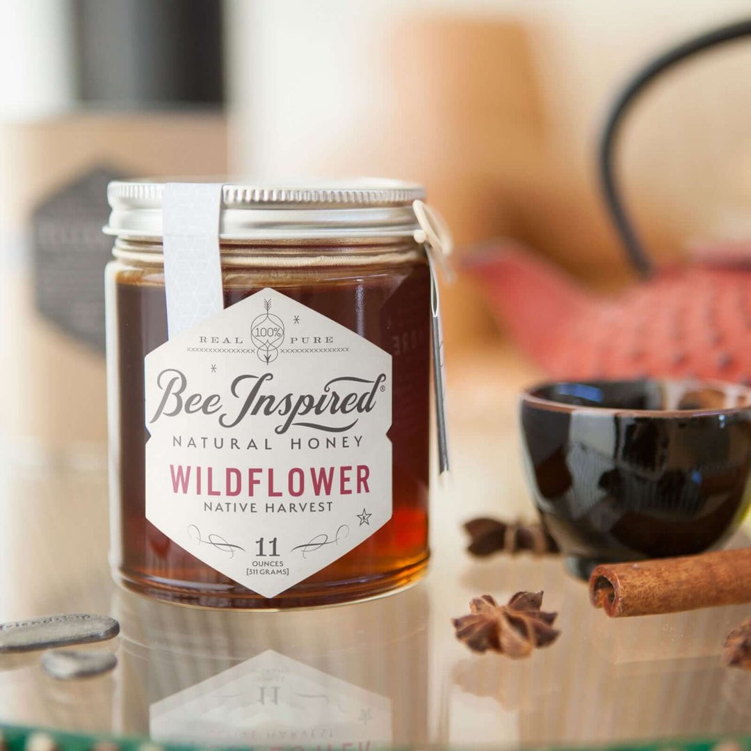 Wildflower honey and cinnamon sticks on glass table