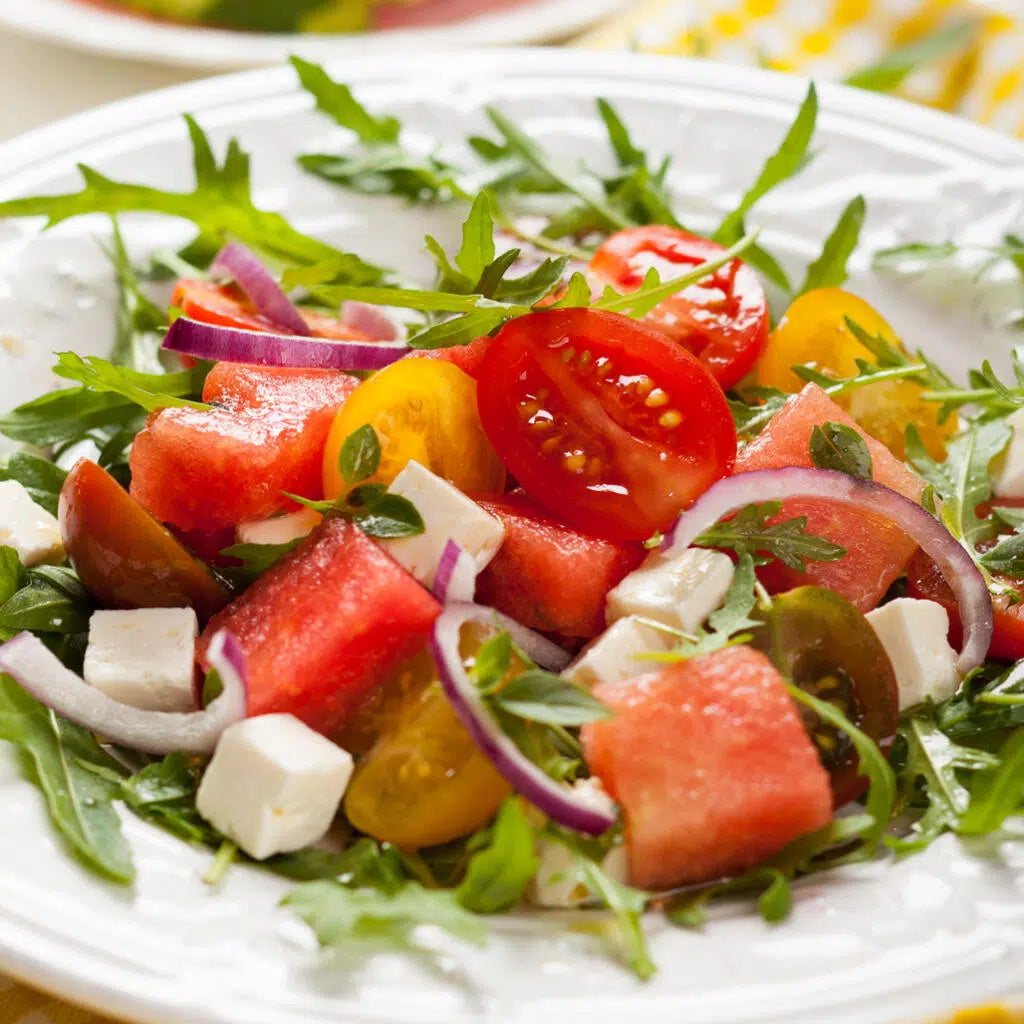 watermelon feta salad on white plate
