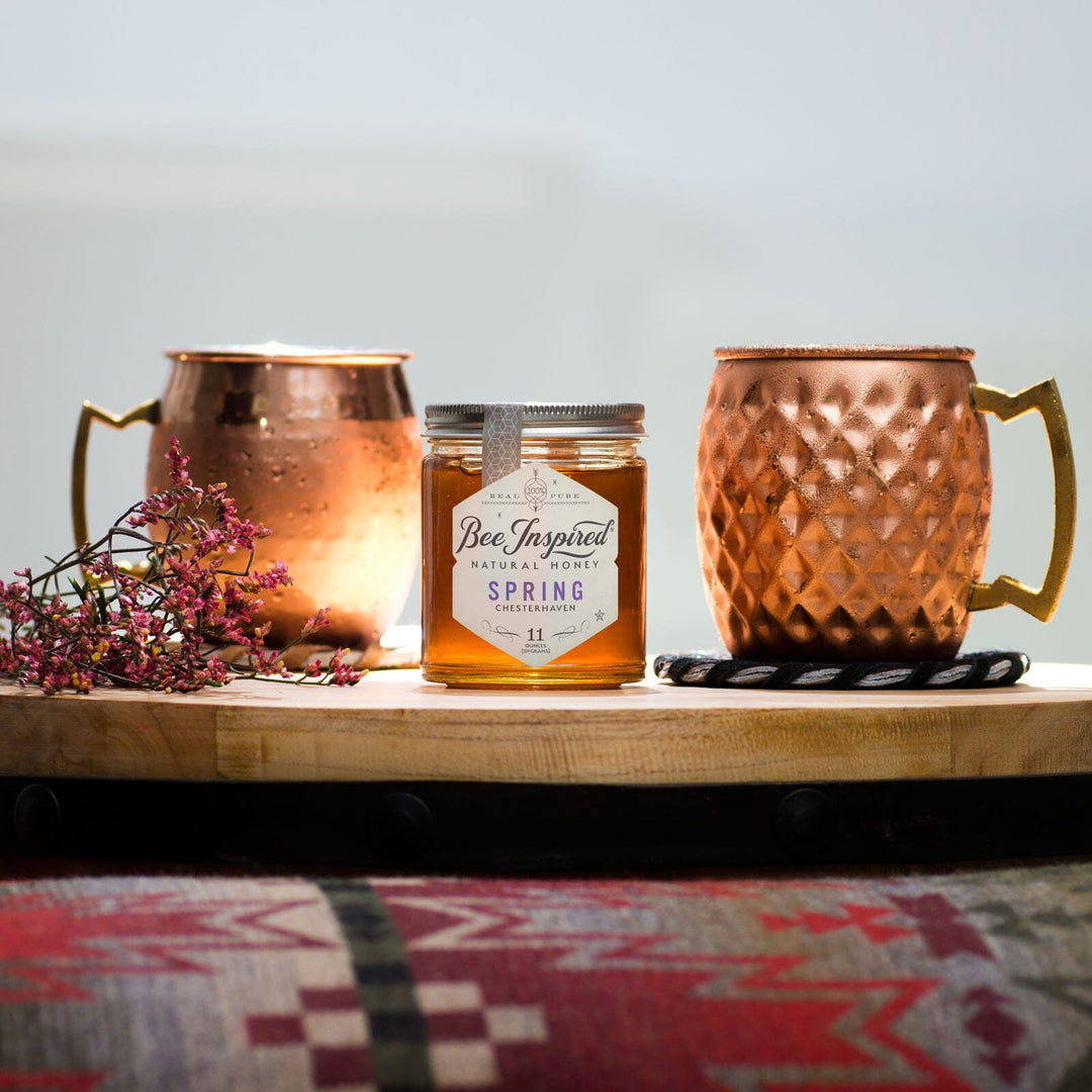 moscow mule in copper cup and jar of bee inspired honey