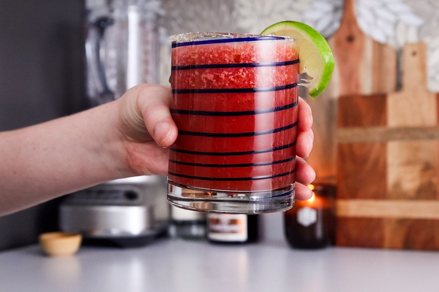 Image of someone holding a finished watermelon margarita